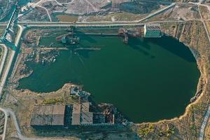man made reservoir by an industrial site